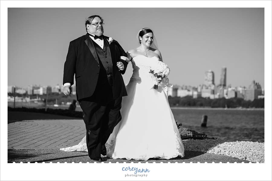 bride and her father walking up the aisle at waterside restaurant and catering