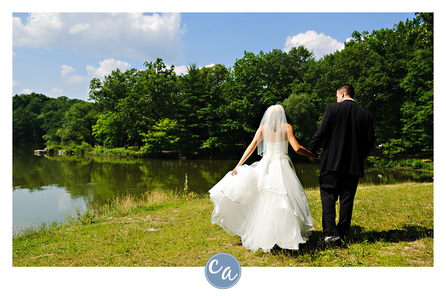 bride and groom walking along wingfoot lake in akron ohio