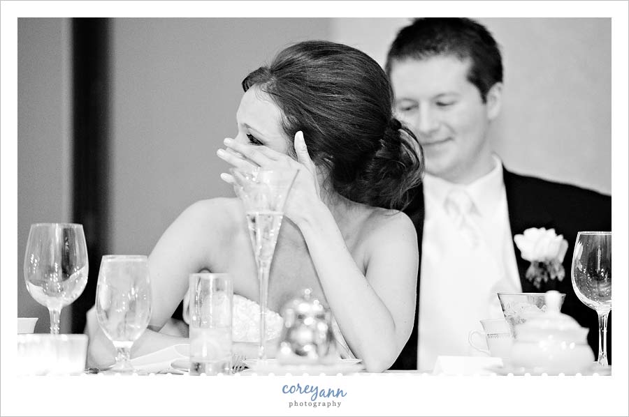 bride wiping a tear away during toasts at la centre in avon ohio