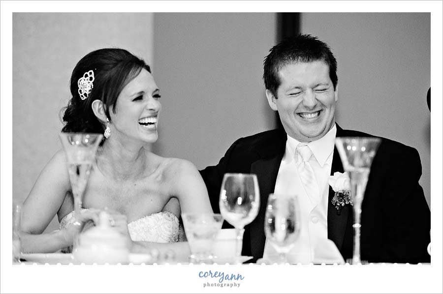 bride and groom laughing during best man's toast