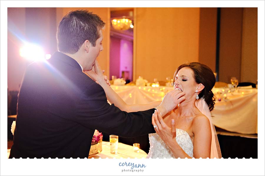 bride and groom feeding cake to one another